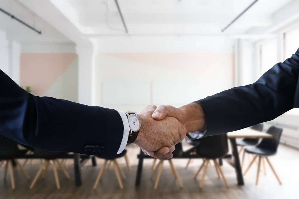 Professionals shaking hands during a hiring conversation